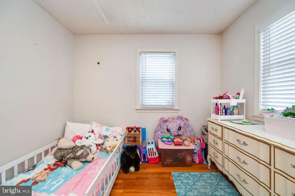 a view of a balcony with lots of furniture and wooden floor