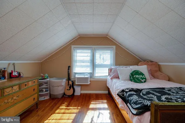a bedroom with a bed and a desk