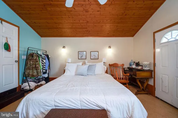 a spacious bedroom with a bed and a table