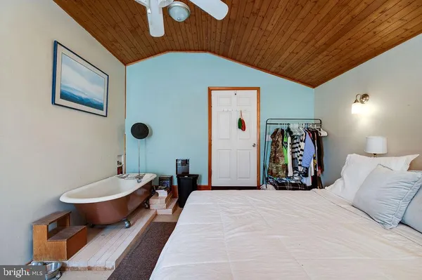 a bedroom with furniture and a chandelier