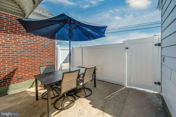 a view of a patio with table and chairs