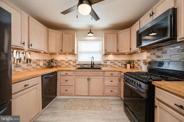 a kitchen with cabinets stainless steel appliances and a sink