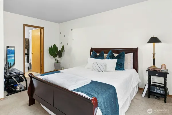 a bedroom with a bed and a table in it