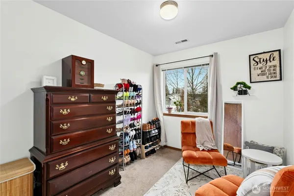a view of a livingroom with furniture and a window