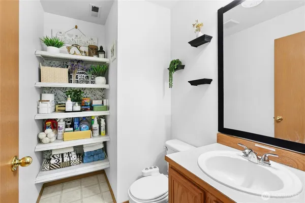 a bathroom with a sink a toilet and a shower curtain