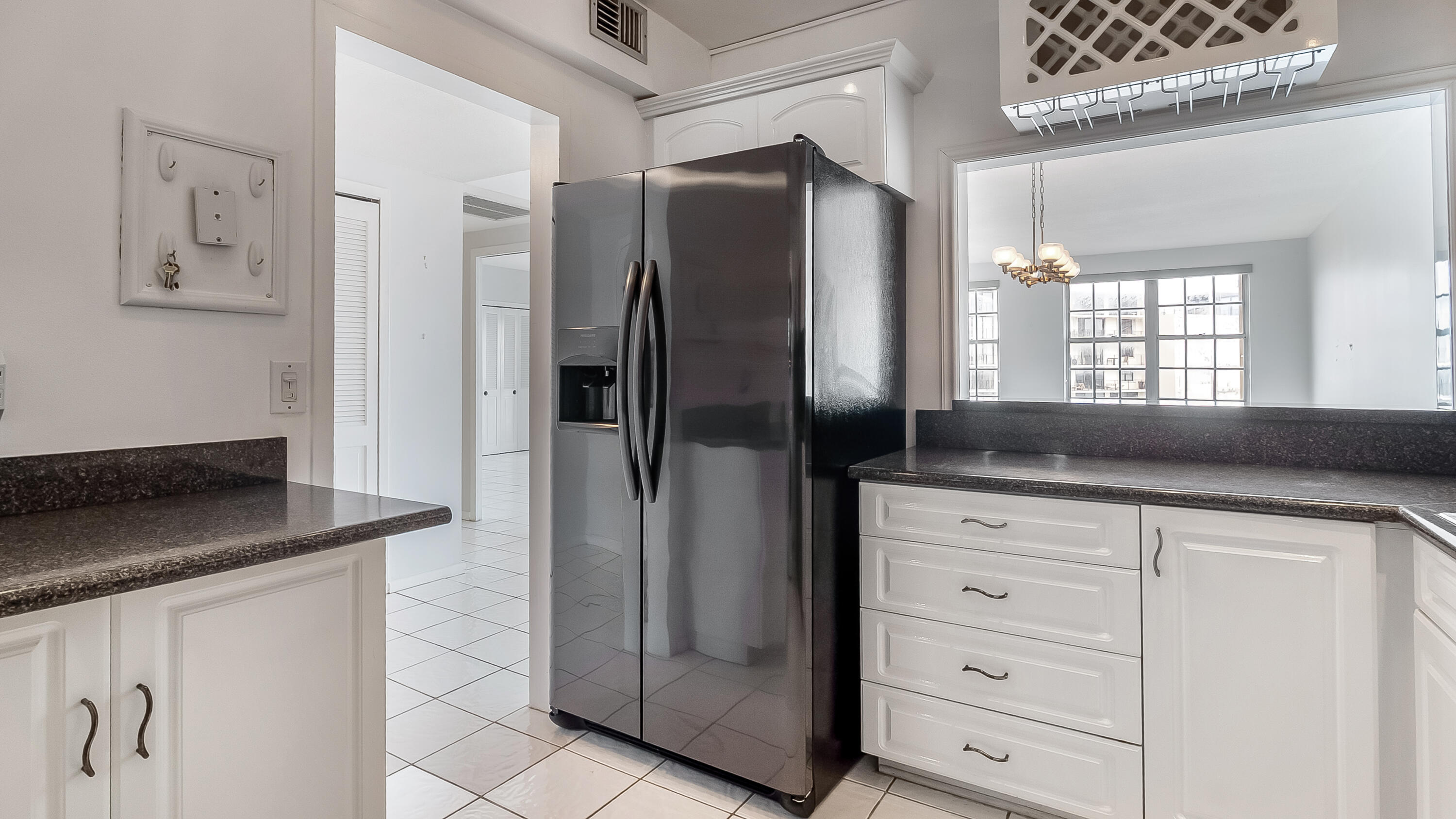 3475 South Ocean Boulevard, Unit 5140 Palm Beach, FL 33480 - Photo 11 of 55 a kitchen with stainless steel appliances granite countertop a refrigerator and a sink