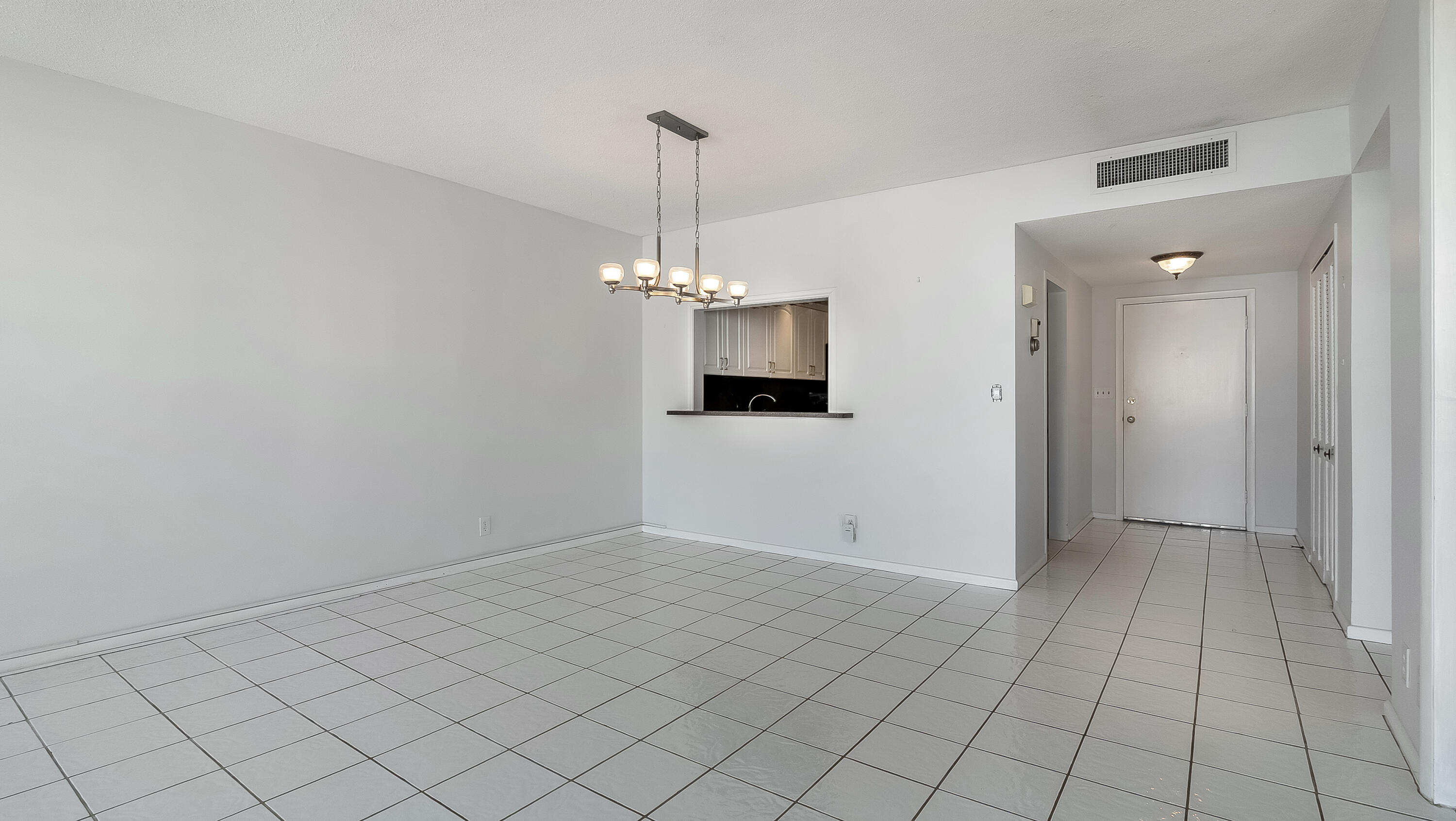 3475 South Ocean Boulevard, Unit 5140 Palm Beach, FL 33480 - Photo 21 of 55 an empty room with a fireplace and chandelier
