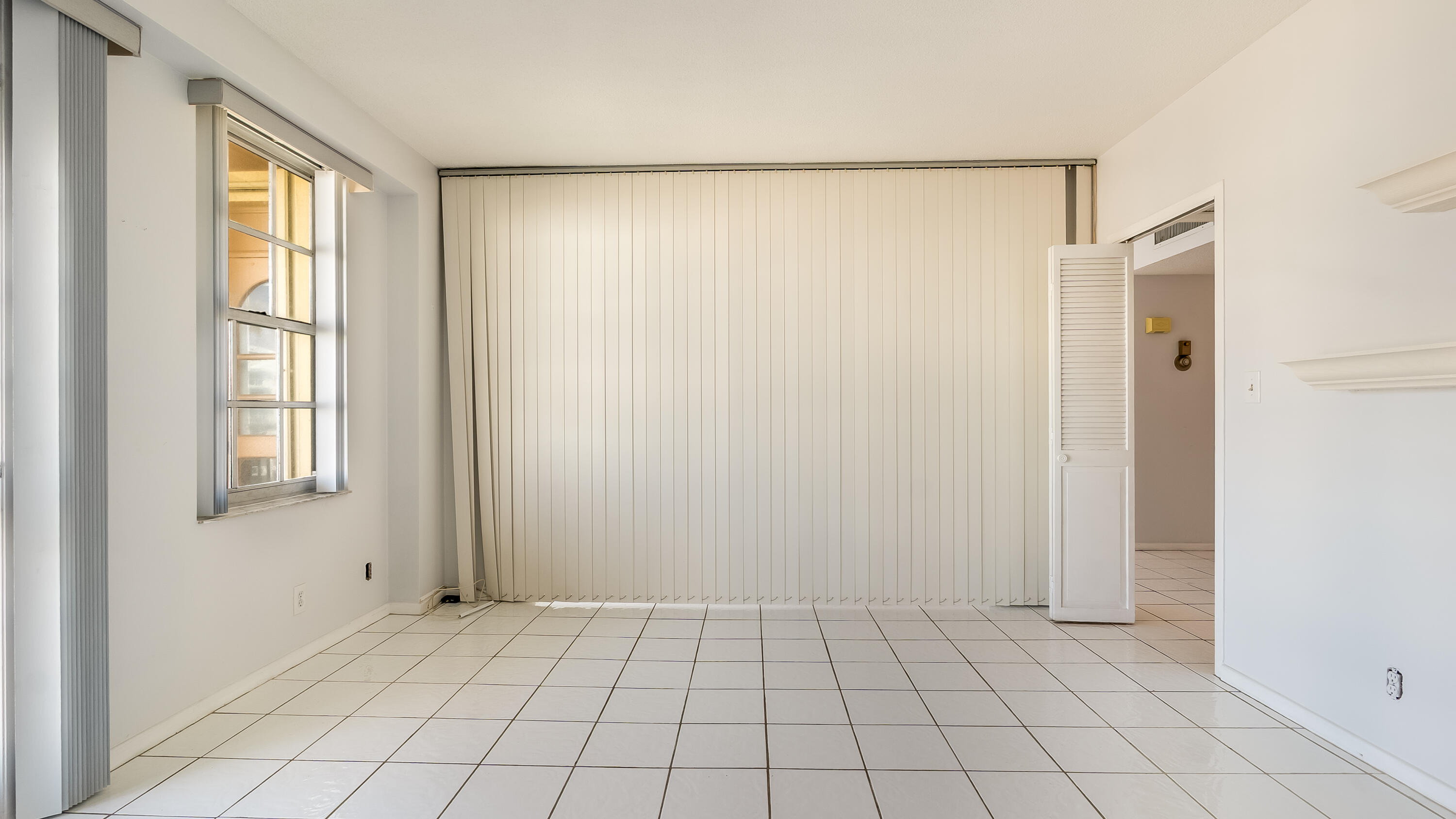 3475 South Ocean Boulevard, Unit 5140 Palm Beach, FL 33480 - Photo 51 of 55 a view of an empty room with window and cabinet area