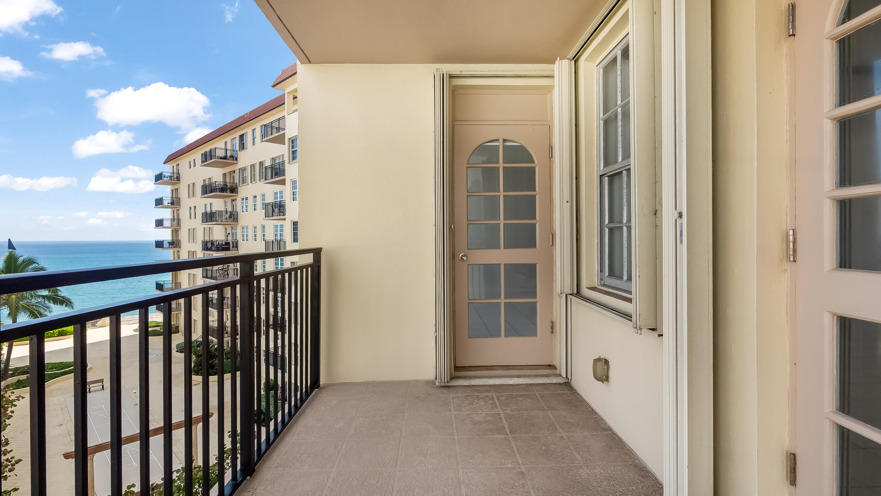 3475 South Ocean Boulevard, Unit 5140 Palm Beach, FL 33480 - Photo 5 of 55 a view of a balcony with wooden floor and fence