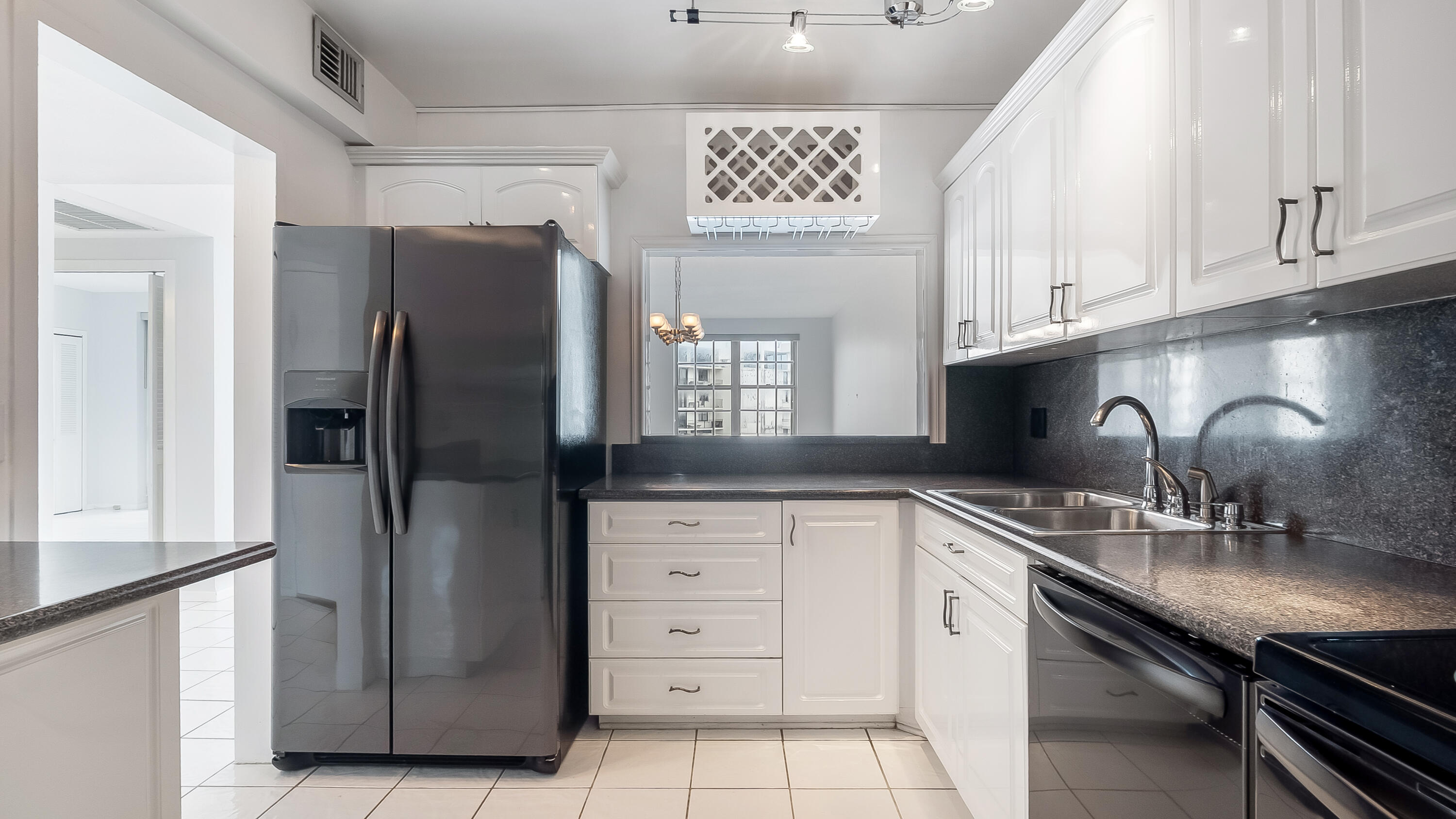 3475 South Ocean Boulevard, Unit 5140 Palm Beach, FL 33480 - Photo 9 of 55 a kitchen with stainless steel appliances granite countertop a refrigerator and a sink