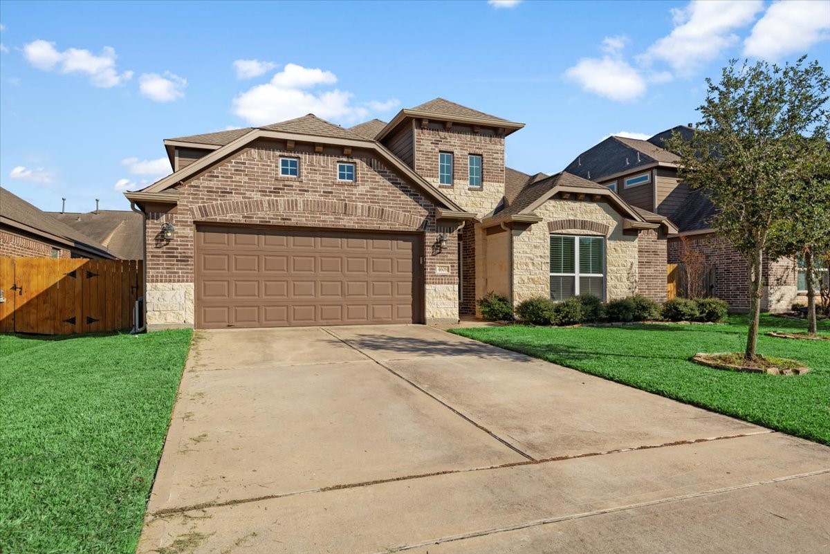 a front view of a house with a yard and garage