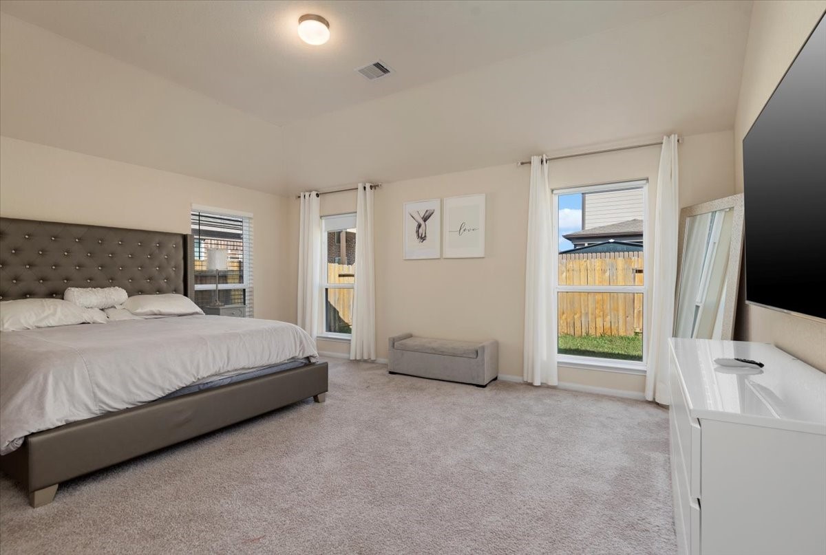 4606 Clara Rose Lane Katy, TX 77449 - Photo 11 of 25 a spacious bedroom with a bed and a flat screen tv