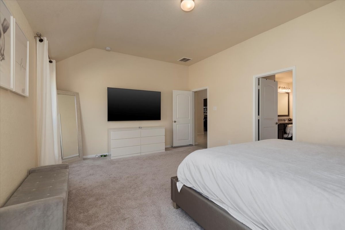 4606 Clara Rose Lane Katy, TX 77449 - Photo 12 of 25 a bedroom with a bed and a flat screen tv