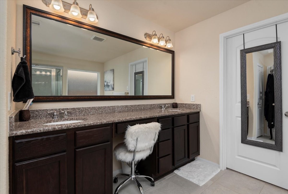 4606 Clara Rose Lane Katy, TX 77449 - Photo 13 of 25 a bathroom with a sink a mirror and a toilet