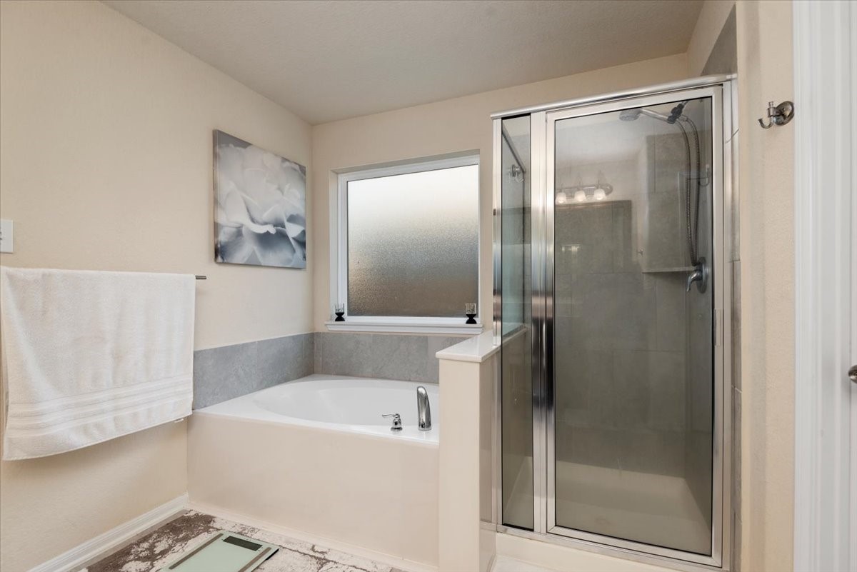 4606 Clara Rose Lane Katy, TX 77449 - Photo 14 of 25 a bathroom with a bathtub and a shower