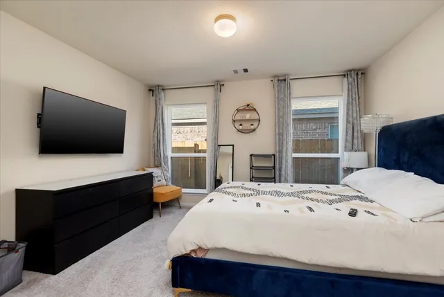 a bedroom with a bed and a flat screen tv
