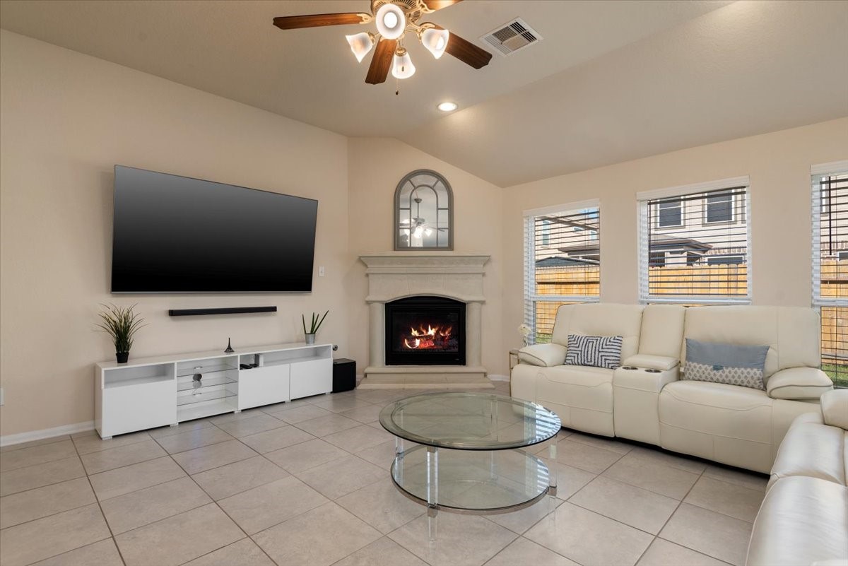 4606 Clara Rose Lane Katy, TX 77449 - Photo 4 of 25 a living room with furniture a flat screen tv and a fireplace