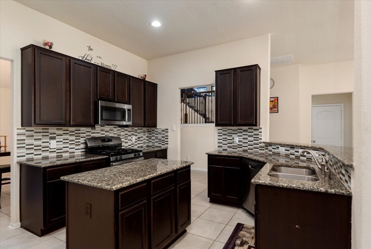 4606 Clara Rose Lane Katy, TX 77449 - Photo 7 of 25 a kitchen with a stove and a refrigerator