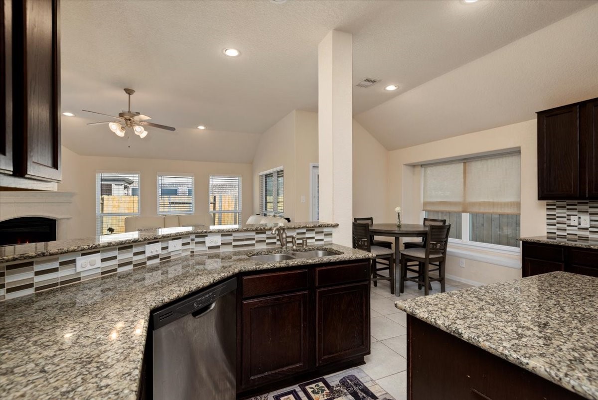 4606 Clara Rose Lane Katy, TX 77449 - Photo 8 of 25 a kitchen with stainless steel appliances kitchen island granite countertop a sink and cabinets