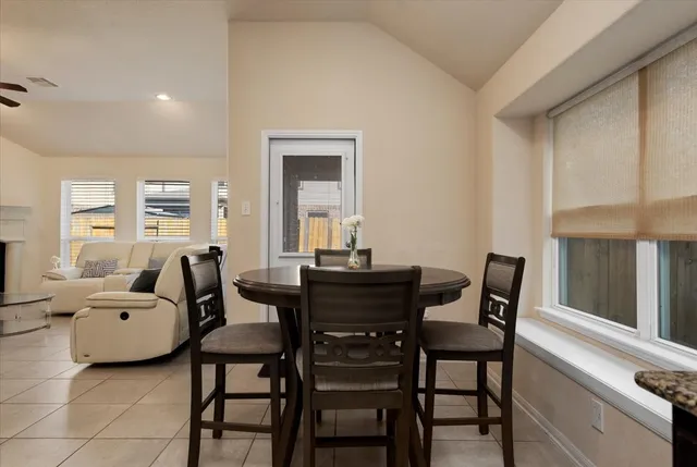 a view of a dining room with furniture and window
