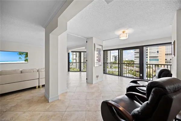 a living room with furniture and white walls