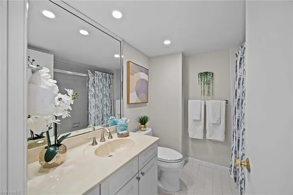 a spacious bathroom with a double vanity sink and a mirror