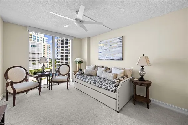a living room with furniture and a ceiling fan