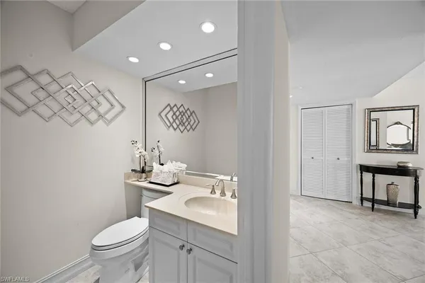 a dining room with furniture and a mirror