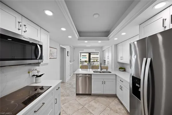 a kitchen that has a refrigerator and a sink
