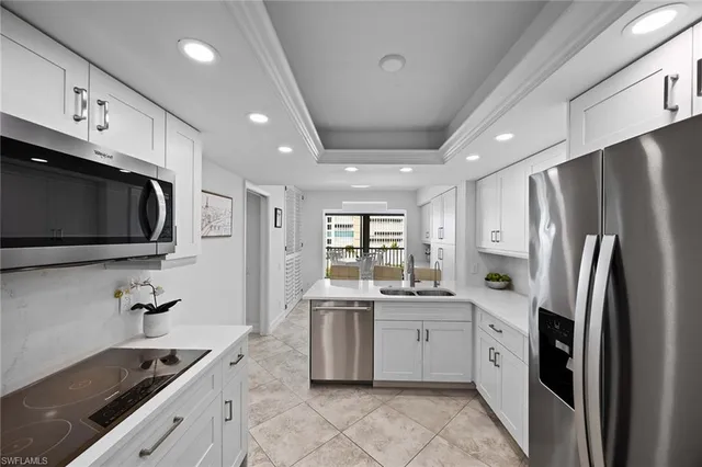 a kitchen that has a refrigerator and a sink