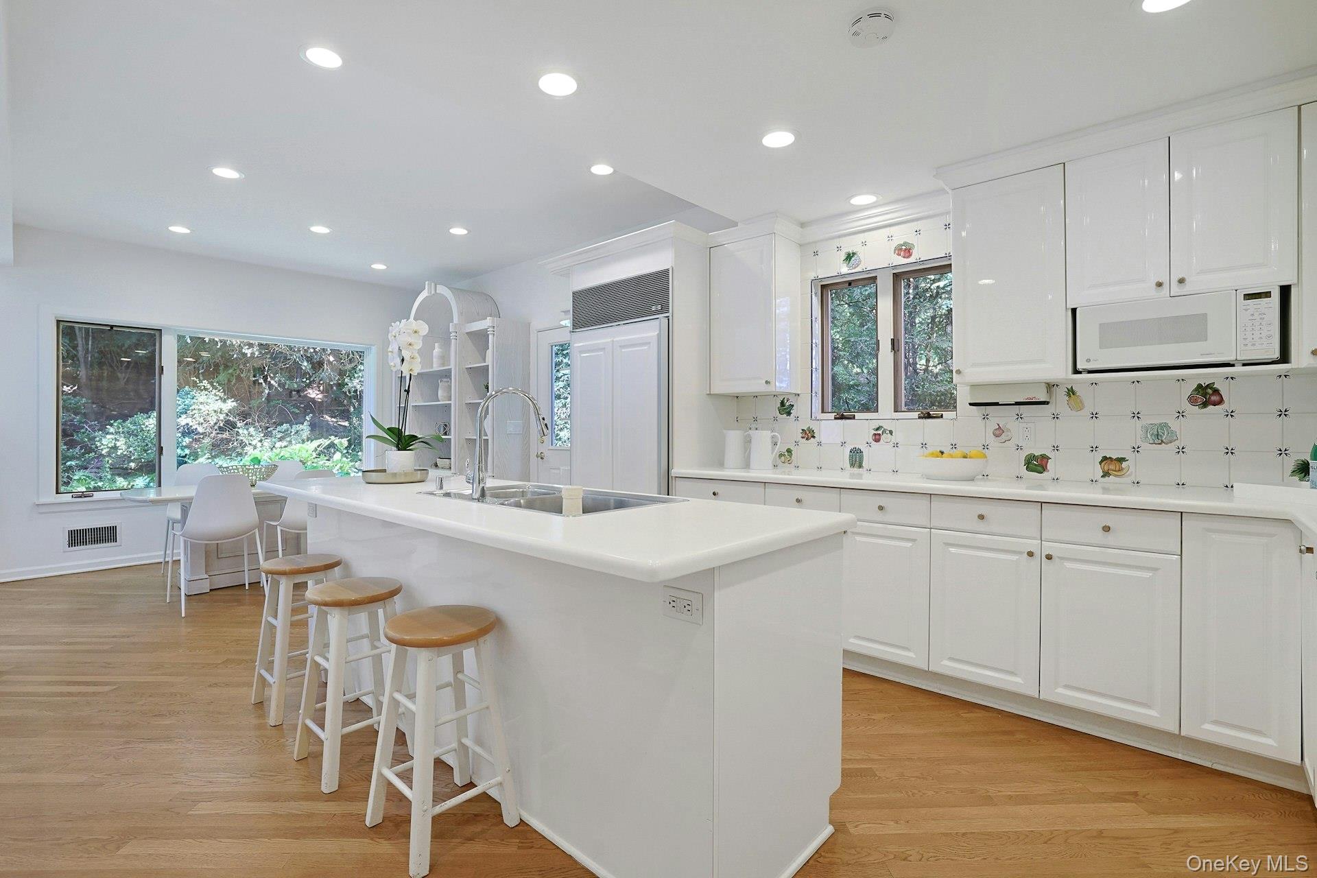 17 Elm Road Scarsdale, NY 10583 - Photo 9 of 38 The spacious kitchen features crisp white cabinetry, premium appliances and an oversized center island with seating for casual meals and conversation.