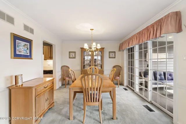 a living room with furniture and floor to ceiling windows