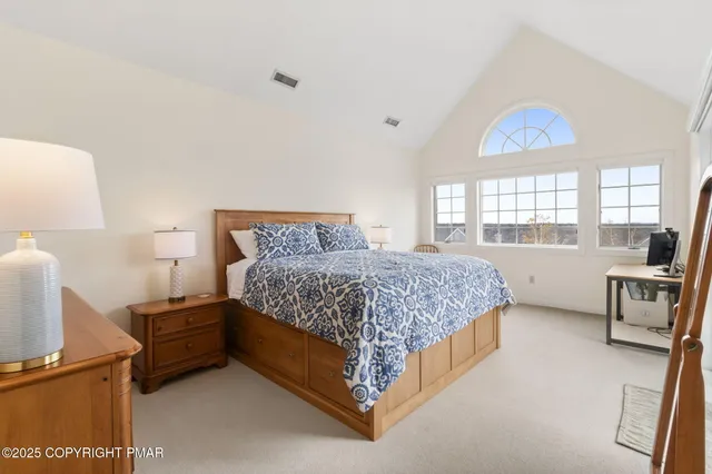 a bedroom with two beds and a chandelier