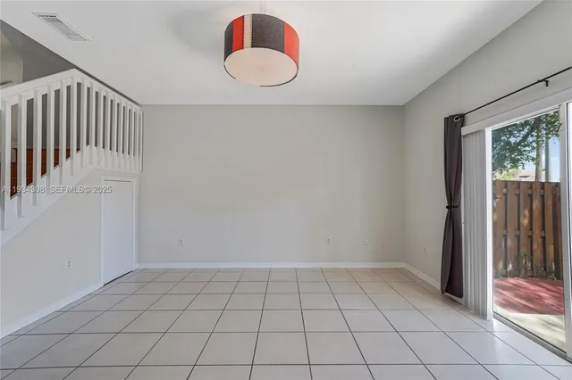 a kitchen with a refrigerator sink and cabinets