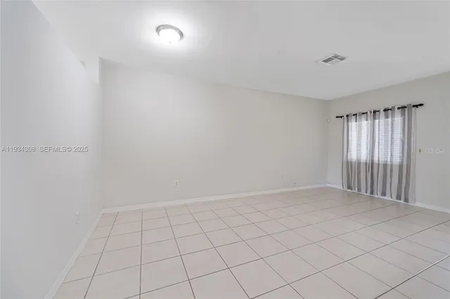 a view of an empty room with windows