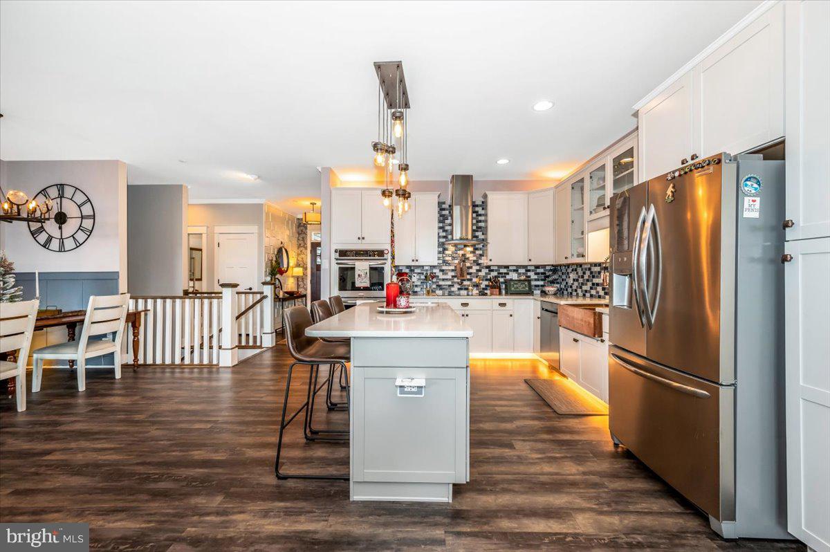 14231 Ridenour Road Smithsburg, MD 21783 - Photo 19 of 76 a kitchen with stainless steel appliances a refrigerator and a stove top oven