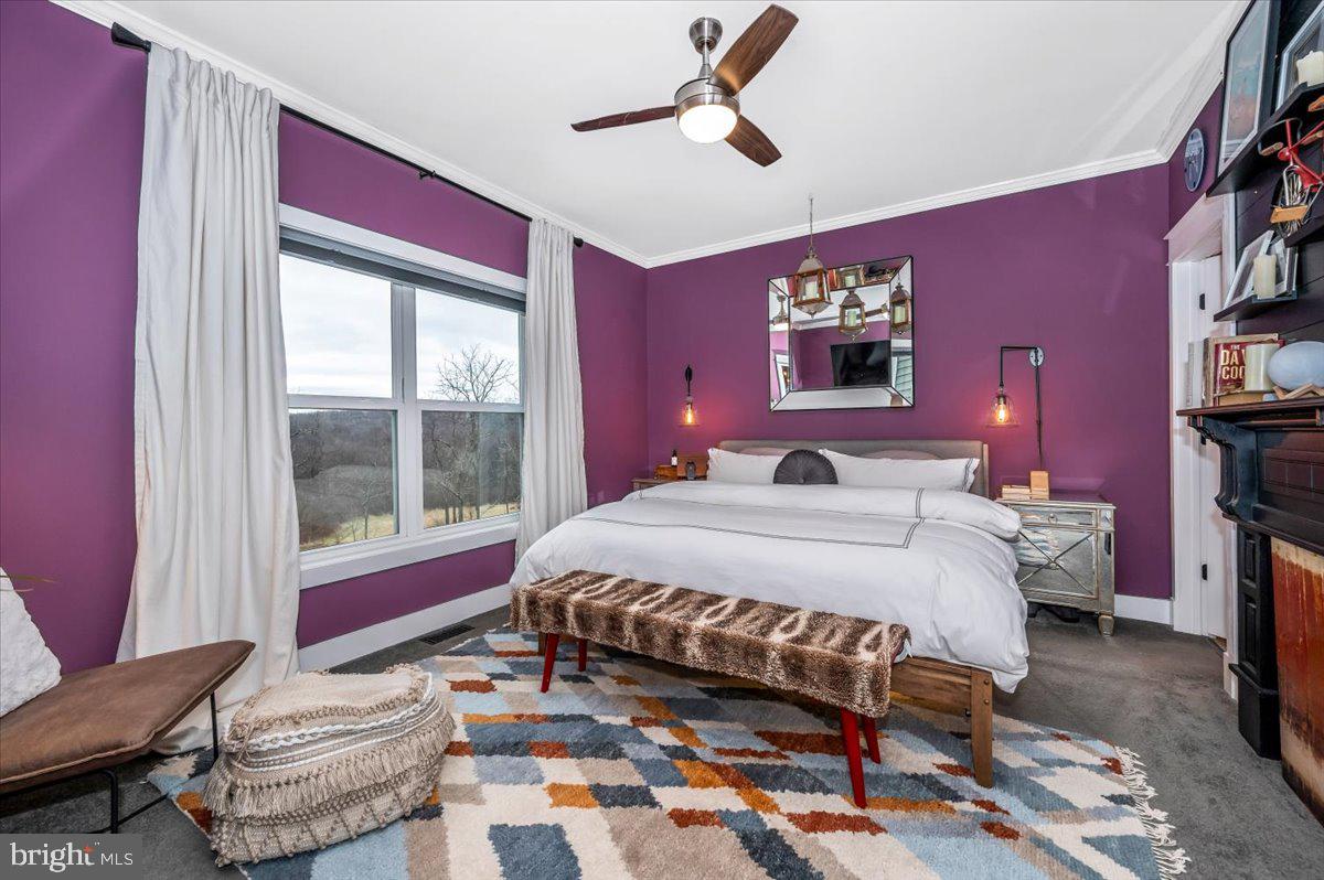 14231 Ridenour Road Smithsburg, MD 21783 - Photo 33 of 76 a bedroom with a bed and a chandelier