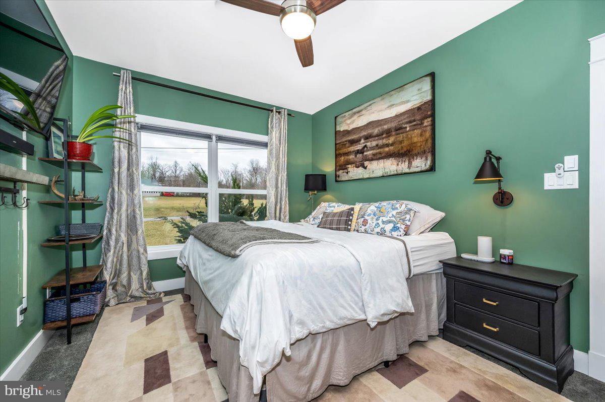 14231 Ridenour Road Smithsburg, MD 21783 - Photo 40 of 76 a bedroom with a bed and a large window