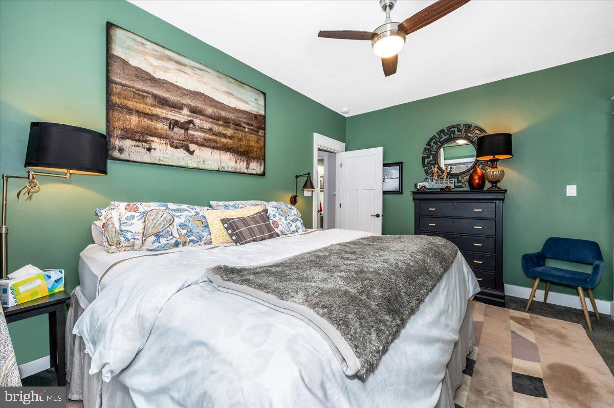 14231 Ridenour Road Smithsburg, MD 21783 - Photo 41 of 76 a bedroom with a bed and a chandelier