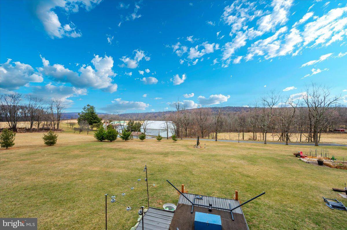 14231 Ridenour Road Smithsburg, MD 21783 - Photo 59 of 76 a swimming pool with lawn chairs