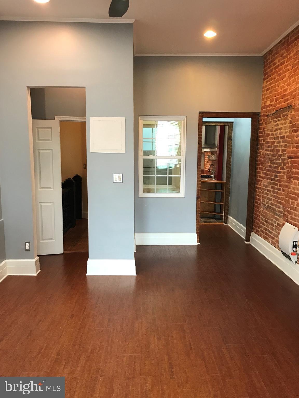1609 Bolton Street Baltimore, MD 21217 - Photo 5 of 16 a view of empty room with wooden floor