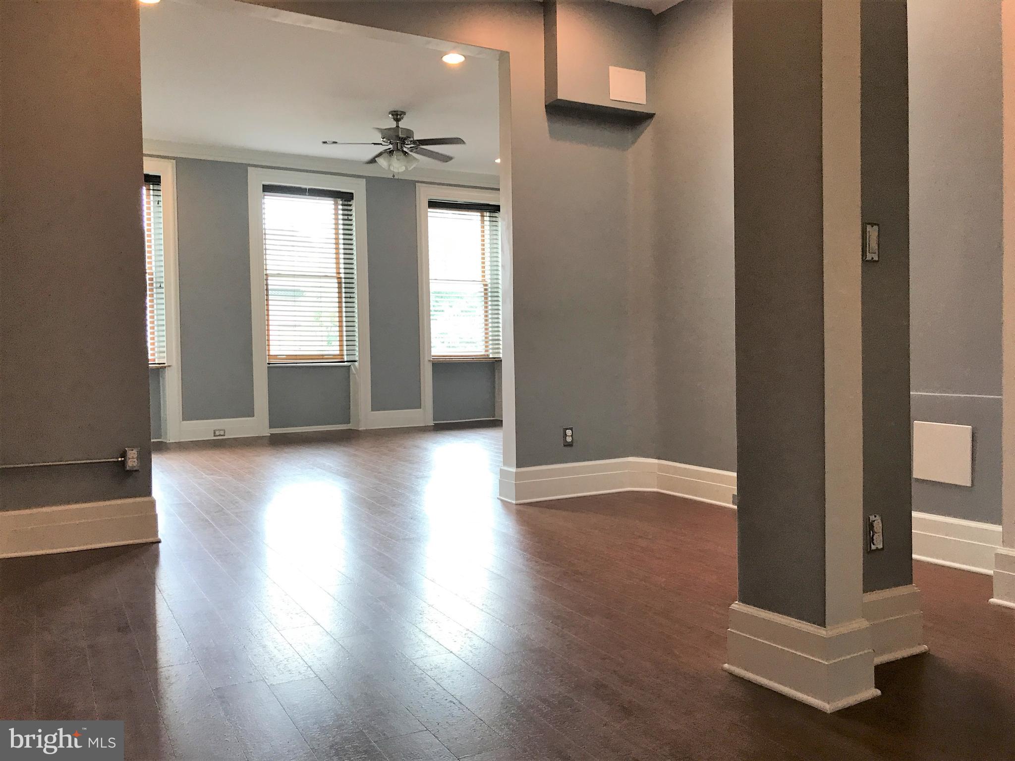 1609 Bolton Street Baltimore, MD 21217 - Photo 6 of 16 a view of a livingroom with wooden floor and a window