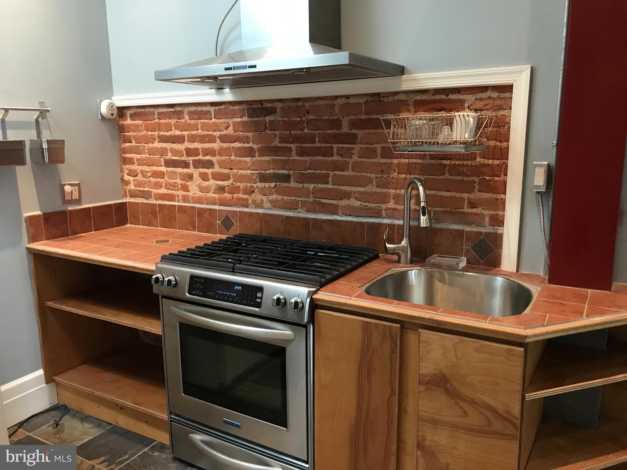 1609 Bolton Street Baltimore, MD 21217 - Photo 7 of 16 a stove top oven sitting inside of a kitchen