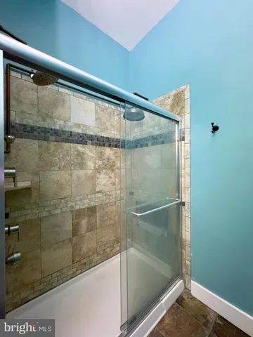 a kitchen with refrigerator and cabinets