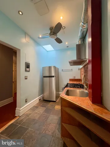 a kitchen with stainless steel appliances granite countertop a stove and a refrigerator