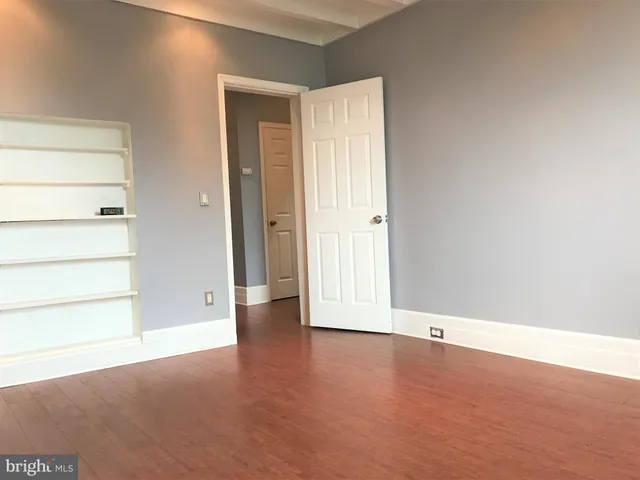 an empty room with a wooden door