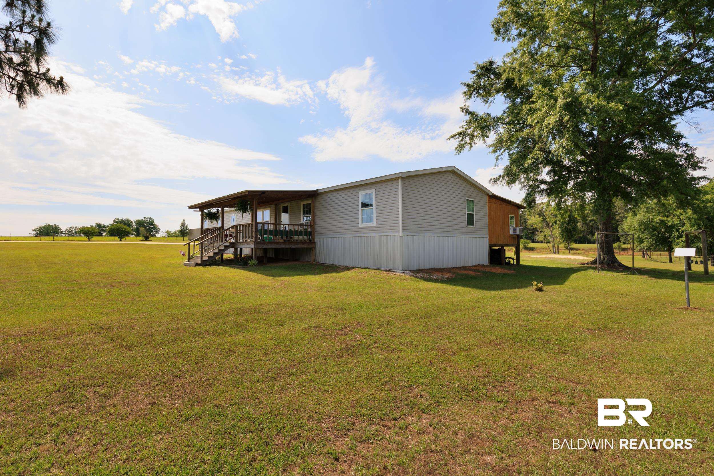 6725 Upper Creek Road Flomaton, AL 36441 - Photo 12 of 61 Back of property featuring a lawn