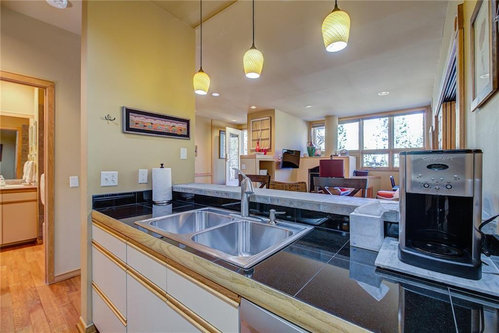 2027 Soda Ridge Road, Unit 1934 Keystone, CO 80435 - Photo 15 of 21 a kitchen with stainless steel appliances granite countertop a sink a counter space and cabinets