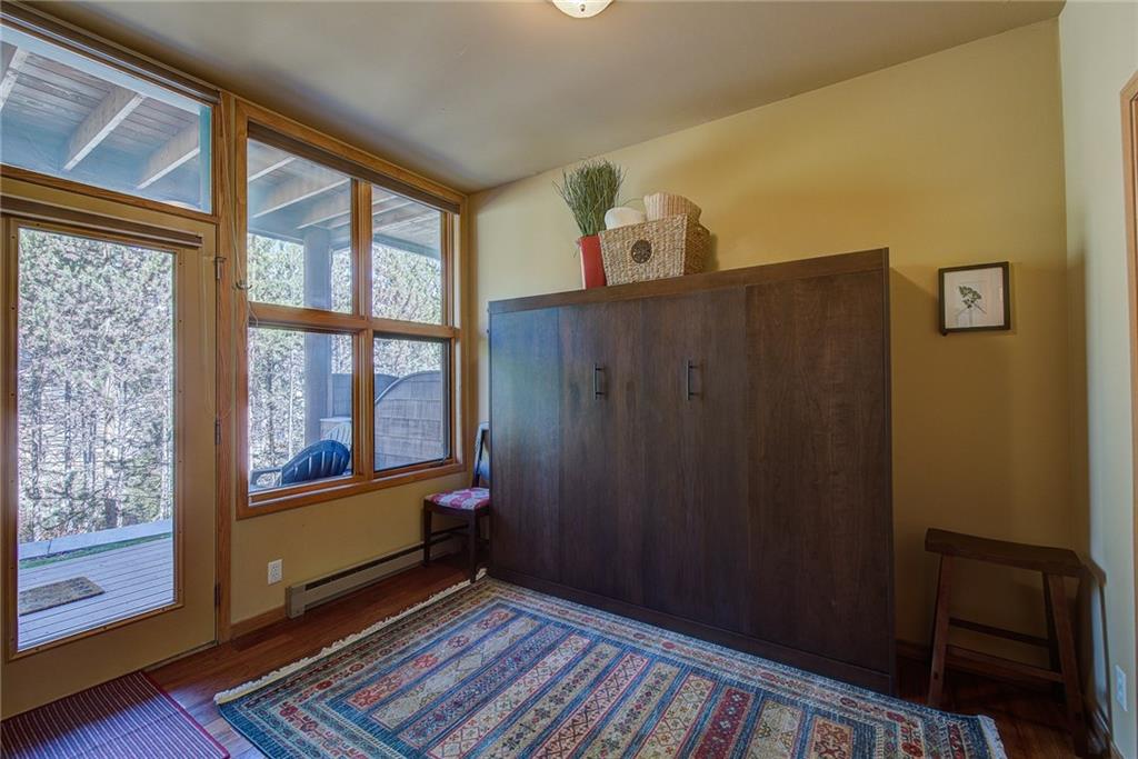 2027 Soda Ridge Road, Unit 1934 Keystone, CO 80435 - Photo 17 of 21 a view of an empty room with wooden floor and a window
