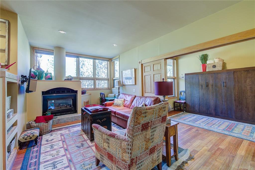 2027 Soda Ridge Road, Unit 1934 Keystone, CO 80435 - Photo 6 of 21 a living room with furniture a fireplace and a table